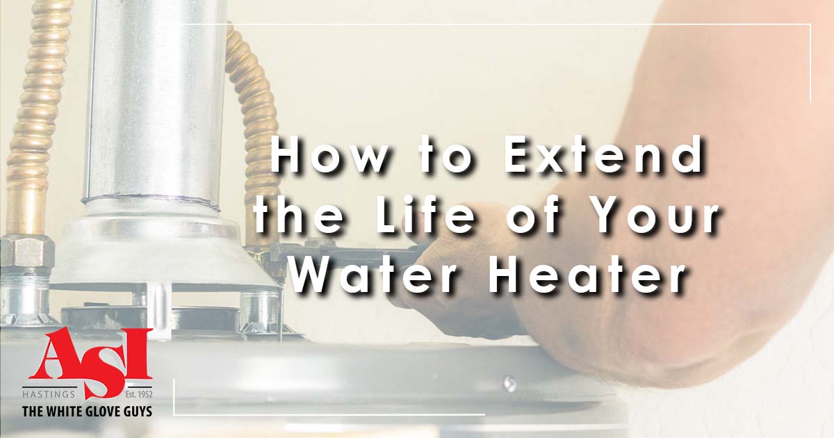 Image: a person working on a water heater, cover image for How to Extend the Life of Your Water Heater.