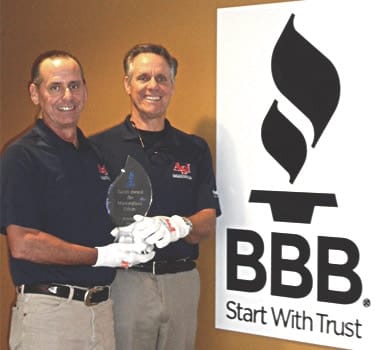 Ken and Phil Justo receiving BBB Torch Award