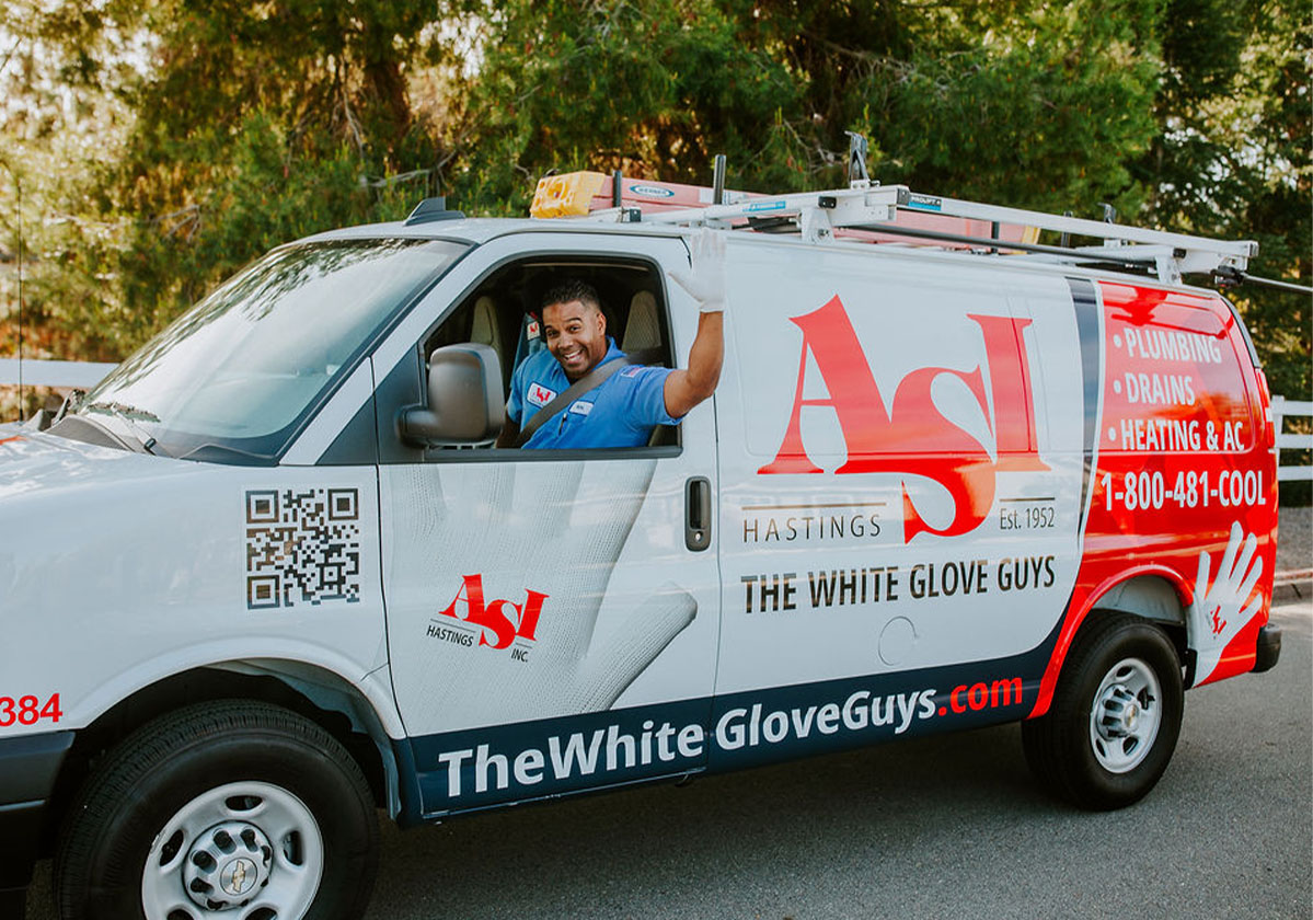 Friendly ASI Hastings technician in a fully branded plumbing, drains, heating and AC service van in San Diego